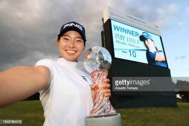 Yuna Nishimura of Japan imitates the selfie after winning the tournament following the final round of the Miyagi TV Cup Dunlop Ladies Open at Rifu...