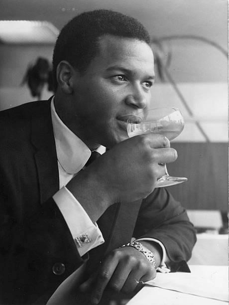 Portrait of Chubby Checker drinking a glass of wine in a restaurant in 1964 in Hamburg, Germany.