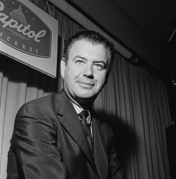 American composer and bandleader Nelson Riddle pictured at a Capitol Records / EMI Records reception in London in August 1961.