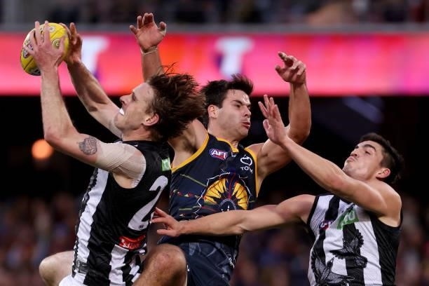 Jordan Roughead of the Magpies clashes with Darcy Fogarty of the Crows during the 2021 AFL Round 12 match between the Adelaide Crows and the...