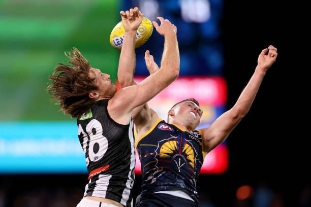 Nathan Murphy of the Magpies clashes with Chayce Jones of the Crows during the 2021 AFL Round 12 match between the Adelaide Crows and the Collingwood...