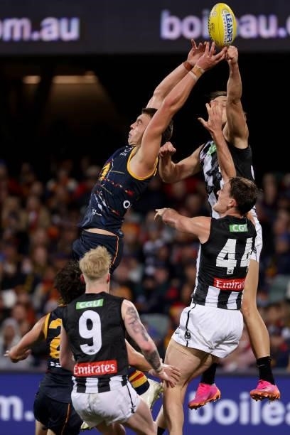 Riley Thilthorpe of the Crows clashes with Darcy Moore of the Magpies during the 2021 AFL Round 12 match between the Adelaide Crows and the...