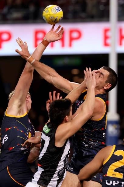 Brayden Maynard of the Magpies clashes with Taylor Walker of the Crows during the 2021 AFL Round 12 match between the Adelaide Crows and the...