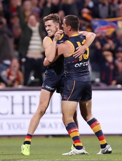 Paul Seedsman of the Crows celebrates a goal with Taylor Walker during the 2021 AFL Round 12 match between the Adelaide Crows and the Collingwood...