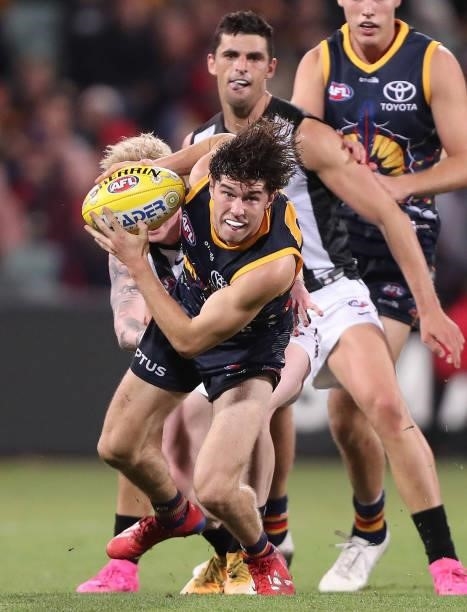 Ned McHenry of the Crows breaks free of John Noble of the Magpies during the 2021 AFL Round 12 match between the Adelaide Crows and the Collingwood...
