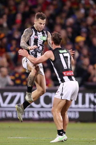 Jamie Elliott of the Magpies celebrates a goal with Callum L. Brown during the 2021 AFL Round 12 match between the Adelaide Crows and the Collingwood...