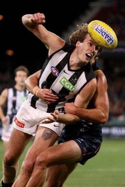 Max Lynch of the Magpies is tackled by Jordon Butts of the Crows during the 2021 AFL Round 12 match between the Adelaide Crows and the Collingwood...