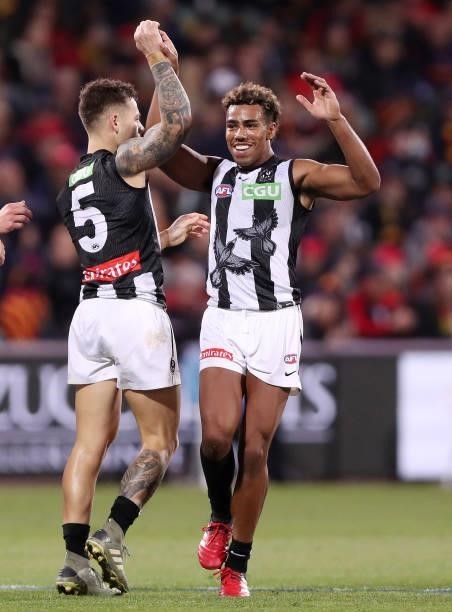 Jamie Elliott of the Magpies celebrates a goal with Isaac Quaynor during the 2021 AFL Round 12 match between the Adelaide Crows and the Collingwood...