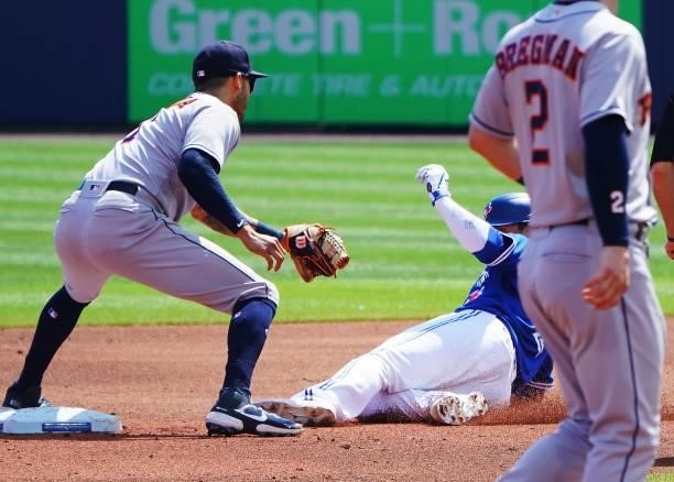 Carlos Correa of the Houston Astros tags out Joe Panik of the Toronto Blue Jays as he tries to take second base during the second inning at Sahlen...