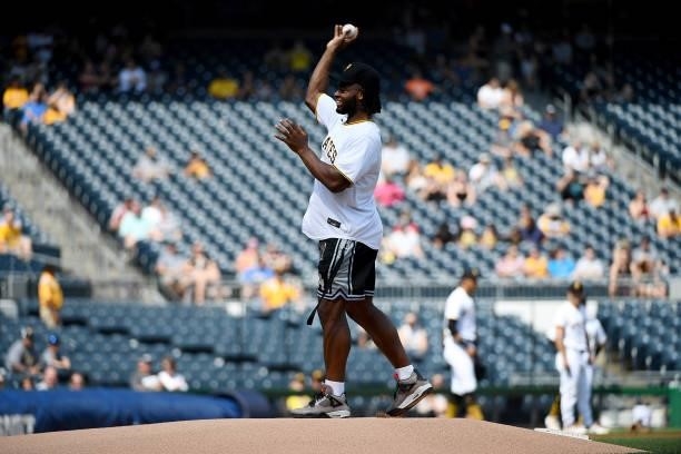 Pittsburgh Steelers First Round Pick Najee Harris throws out the first pitch before the start of the game between the Pittsburgh Pirates and the...