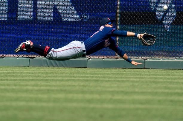 Gilberto Celestino of the Minnesota Twins dives for a Kansas City Royals hit into right center field in the first inning at Kauffman Stadium on June...