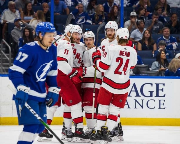The Carolina Hurricanes celebrate a goal against the Tampa Bay Lightning during the second period in Game Four of the Second Round of the 2021...