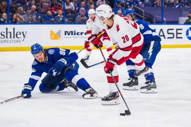 Sebastian Aho of the Carolina Hurricanes skates against Mikhail Sergachev of the Tampa Bay Lightning during the second period in Game Four of the...