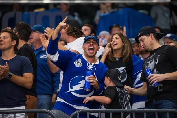 Fans of the Tampa Bay Lightning celebrate a goal against the Carolina Hurricanes during the second period in Game Four of the Second Round of the...