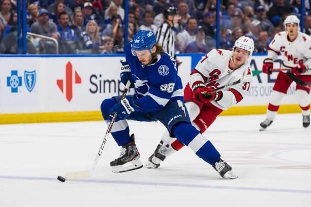 Mikhail Sergachev of the Tampa Bay Lightning skates against Andrei Svechnikov of the Carolina Hurricanes during the second period in Game Four of the...