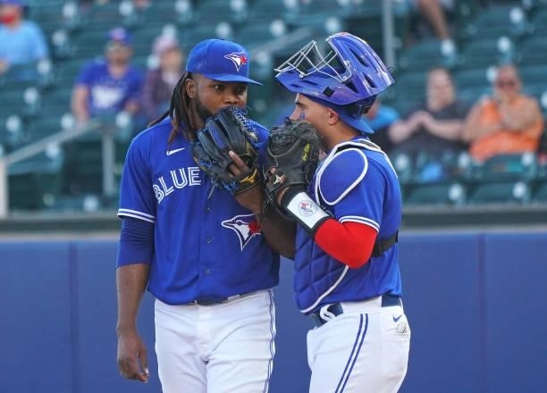 Rafael Dolis of the Toronto Blue Jays and Reese McGuire talk during the ninth inning of the game against the Houston Astros at Sahlen Field on June...