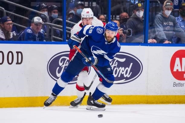 Barclay Goodrow of the Tampa Bay Lightning skates against Martin Necas of the Carolina Hurricanes during the third period in Game Four of the Second...