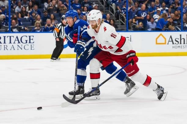 Ondrej Palat of the Tampa Bay Lightning skates against Dougie Hamilton of the Carolina Hurricanes during the three period in Game Four of the Second...