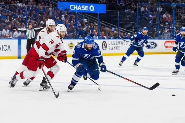 Brayden Point of the Tampa Bay Lightning skates against Jaccob Slavin of the Carolina Hurricanes during the three period in Game Four of the Second...