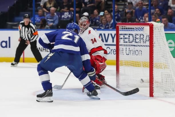 Brayden Point of the Tampa Bay Lightning shoots the puck for a goal against goalie Petr Mrazek of the Carolina Hurricanes during the first period in...