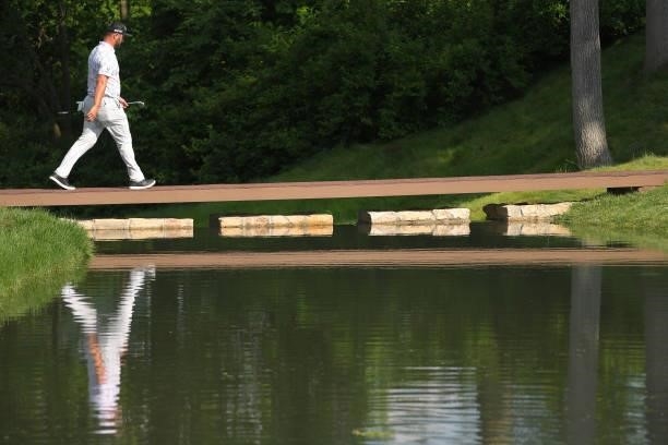 Jon Rahm of Spain walks across the bridge on 15th hole during the third round of the Memorial Tournament presented by Nationwide at Muirfield Village...