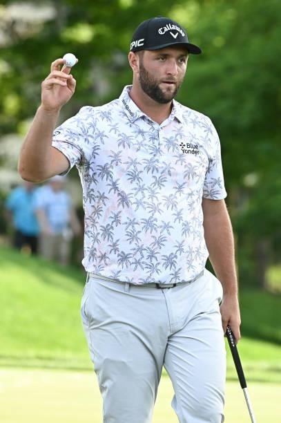 Jon Rahm of Spain raises his ball to fans on the 17th green during the third round of the Memorial Tournament presented by Nationwide at Muirfield...