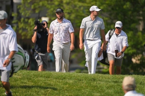 Jon Rahm of Spain and Patrick Cantlay walk towards the 16th tee box during the third round of the Memorial Tournament presented by Nationwide at...