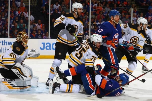 Connor Clifton of the Boston Bruins falls on top of Jordan Eberle of the New York Islanders during the first period in Game Four of the Second Round...