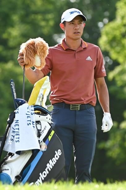 Collin Morikawa takes a club from his bag on the 18th tee box during the third round of the Memorial Tournament presented by Nationwide at Muirfield...