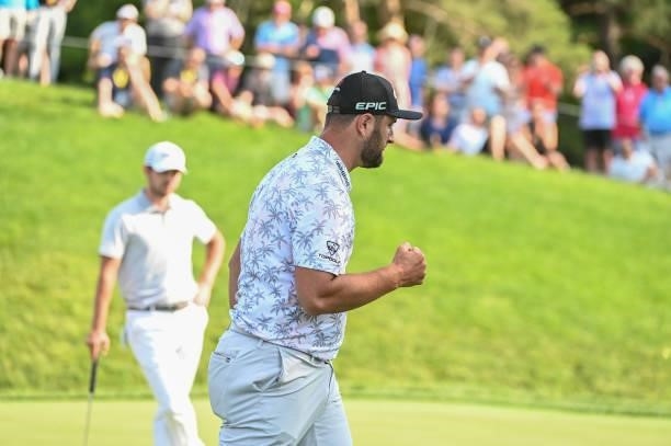 Jon Rahm of Spain fist pumps while making a putt on the 17th green during the third round of the Memorial Tournament presented by Nationwide at...