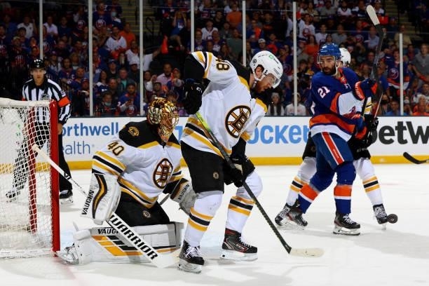Matt Grzelcyk and Tuukka Rask of the Boston Bruins save shot on goal by the New York Islanders during the first period in Game Four of the Second...