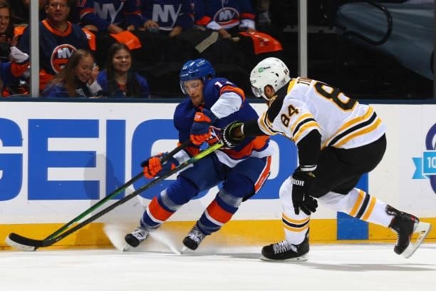 Mathew Barzal of the New York Islanders and Jarred Tinordi of the Boston Bruins race for control of the puck during the first period in Game Four of...