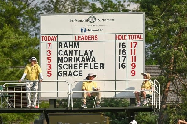 Volunteers are seen near the scoreboard on the 17th hole during the third round of the Memorial Tournament presented by Nationwide at Muirfield...