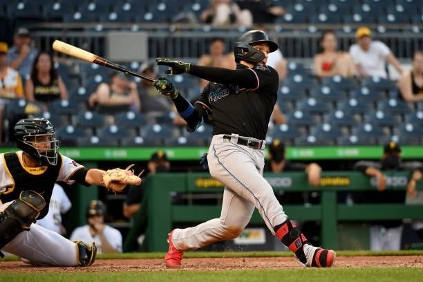 Isan Diaz of the Miami Marlins hits a sacrifice fly ball to score a run in the tenth inning during the game against the Pittsburgh Pirates at PNC...