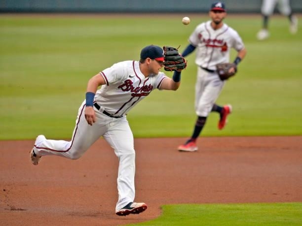 Austin Riley of the Atlanta Braves misses a ground ball hit by Justin Turner of the Los Angeles Dodgers in the first inning at Truist Park on June 5,...