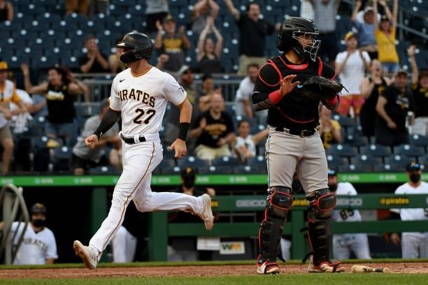Kevin Newman of the Pittsburgh Pirates comes around to score after a missed catch error by Anthony Bender of the Miami Marlins in the eighth inning...