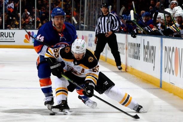 Brad Marchand of the Boston Bruins handles the puck against Jean-Gabriel Pageau of the New York Islanders during the second period in Game Four of...