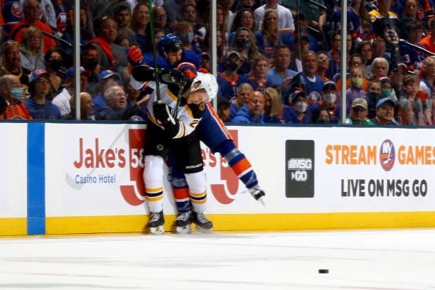 Curtis Lazar of the Boston Bruins checks Mathew Barzal of the New York Islanders into the boards during the first period in Game Four of the Second...