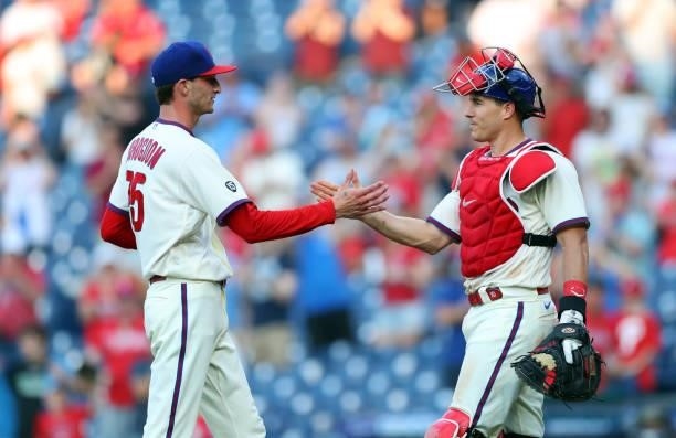 Connor Brogdon of the Philadelphia Phillies is congratulated by J.T. Realmuto after recording a save during a game against the Washington Nationals...