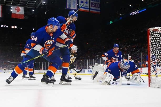 Semyon Varlamov of the New York Islanders saves a shot on goal by Brad Marchand of the Boston Bruins during the first period in Game Four of the...