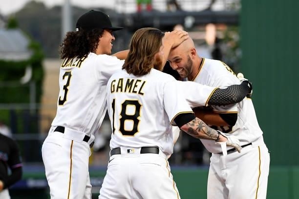 Jacob Stallings of the Pittsburgh Pirates celebrates Cole Tucker and Ben Gamel after hitting a walk off single in the thirteenth inning to give the...