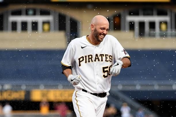 Jacob Stallings of the Pittsburgh Pirates reacts after being doused with water following a walk off single in the thirteenth inning to give the...