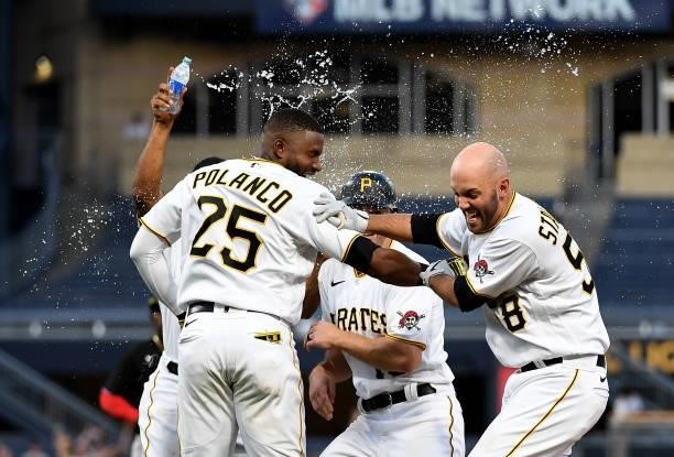 Jacob Stallings of the Pittsburgh Pirates is doused with water by Wilmer Difo following a walk off single in the thirteenth inning to give the...