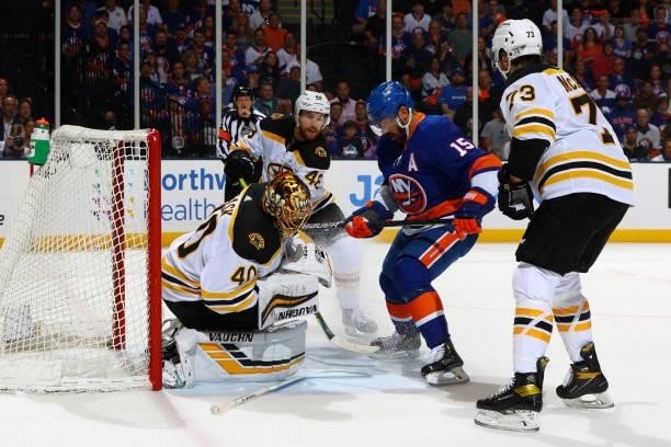 Cal Clutterbuck of the New York Islanders waits for a chance for a shot on goal against Tuukka Rask of the Boston Bruins during the first period in...
