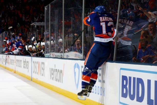 Mathew Barzal of the New York Islanders jumps against the boards as he celebrates his goal against the Boston Bruins during the third period in Game...