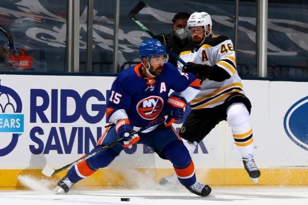 Cal Clutterbuck of the New York Islanders handles the puck against David Krejci of the Boston Bruins during the second period in Game Four of the...