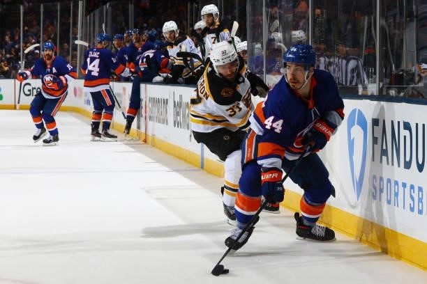 Jean-Gabriel Pageau of the New York Islanders handles the puck against Patrice Bergeron of the Boston Bruins during the third period in Game Four of...