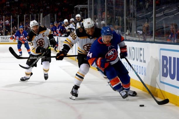 Jean-Gabriel Pageau of the New York Islanders handles the puck against David Pastrnak of the Boston Bruins during the third period in Game Four of...