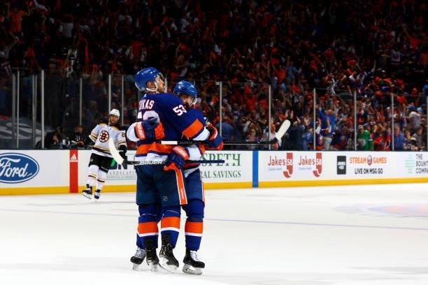 Casey Cizikas of the New York Islanders celebrates with teammate Cal Clutterbuck after scoring a goal against the Boston Bruins during the third...