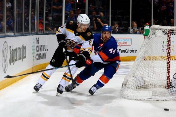 Mike Reilly of the Boston Bruins and Jean-Gabriel Pageau of the New York Islanders race for the puck during the third period in Game Four of the...